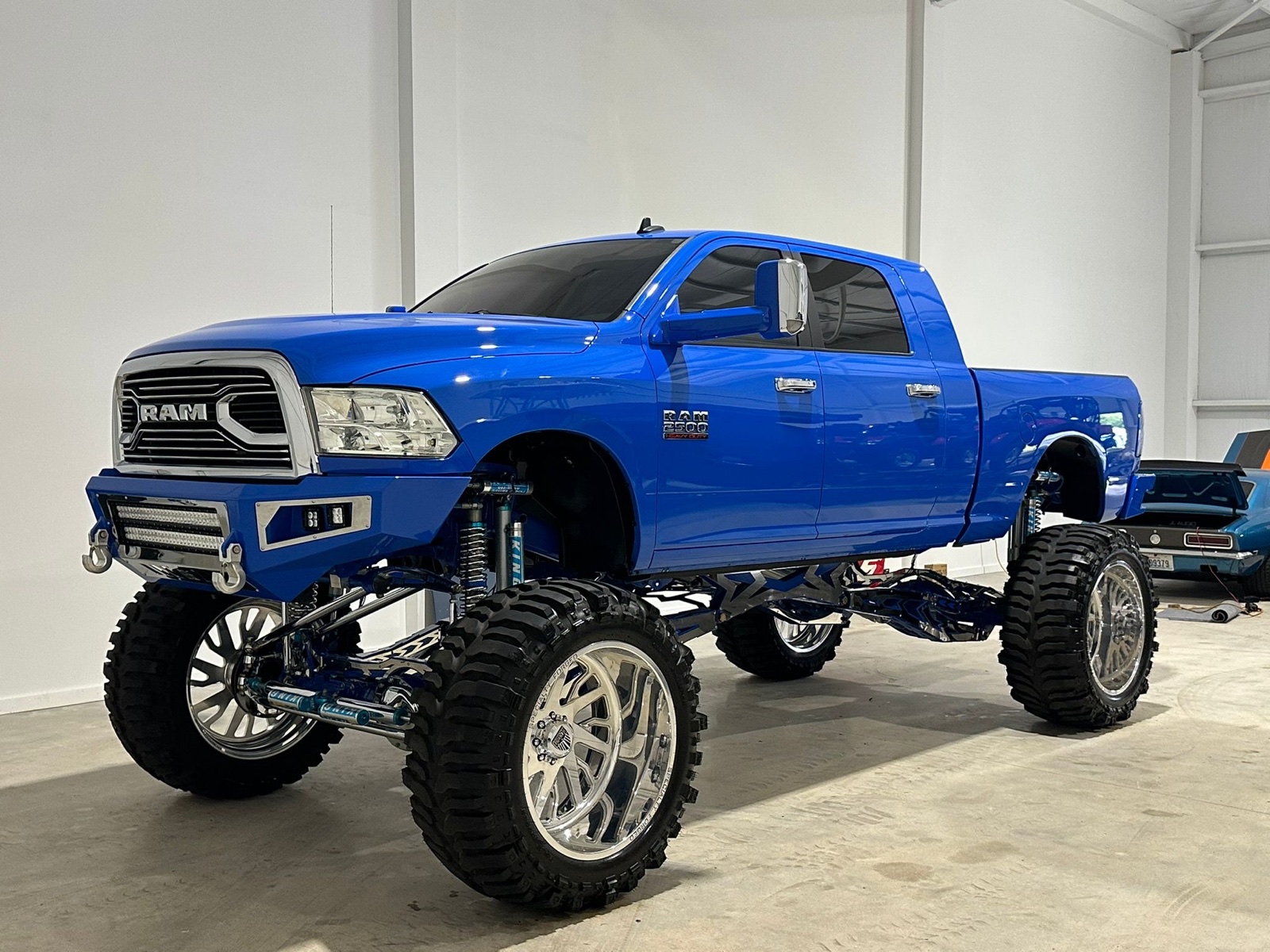 Lifted blue RAM 2500 detailed in the studio