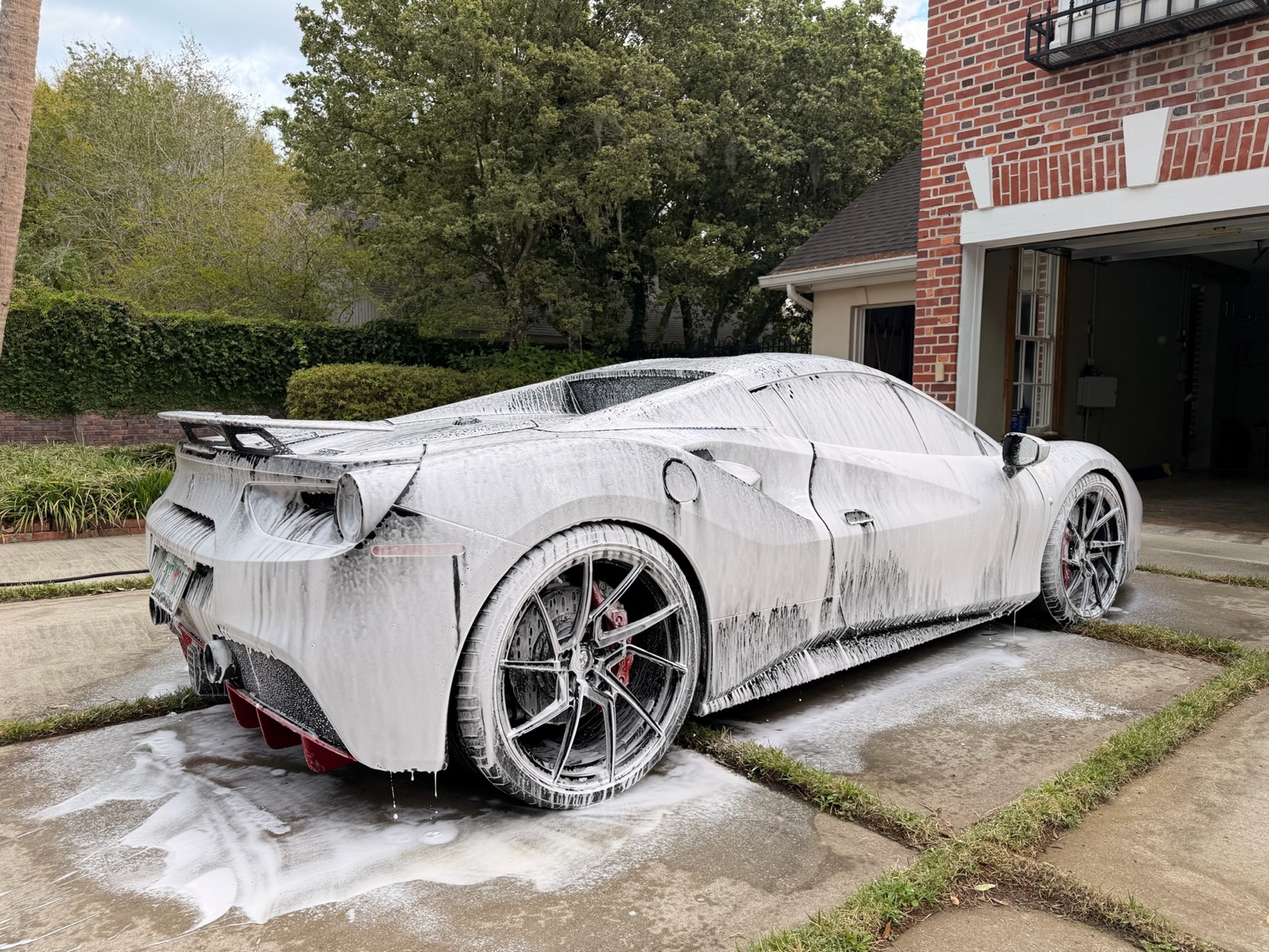 White Ferrari 488 during a foam wash